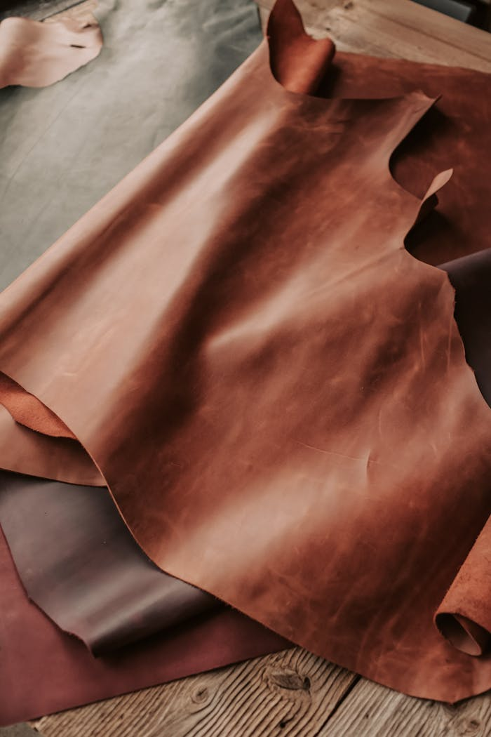 High-quality brown leather sheets displayed in a crafting workshop.
